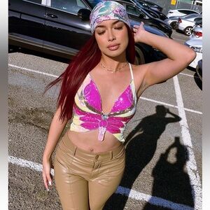 Entire outfit: Butterfly top, brown leather pants, floral bandana